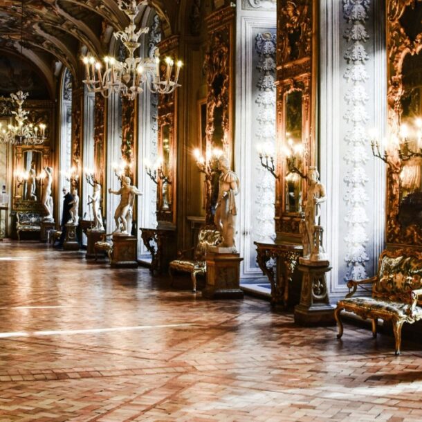 A grand historical hall filled with ornate mirrors, chandeliers, and classical statues, symbolizing the cultural heritage and traditions shaped by centuries of etiquette.