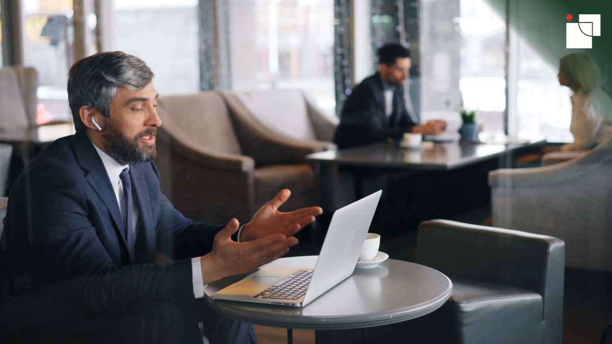 Businessman in a suit speaking during a video call on a laptop
